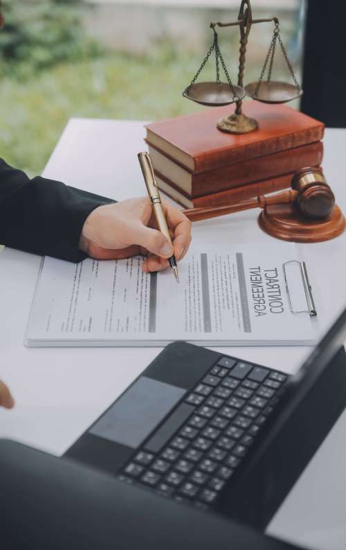 Business and lawyers discussing contract papers with brass scale on desk in office. Law, legal services, advice, justice and law concept picture with film grain effect